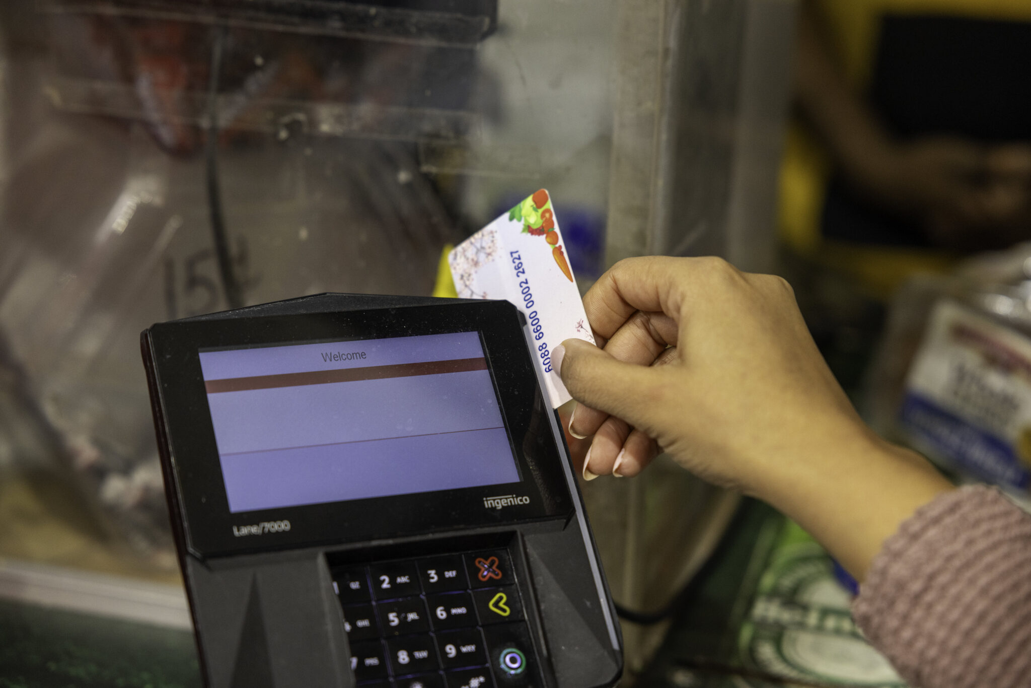 hand sliding ebt card through processor
