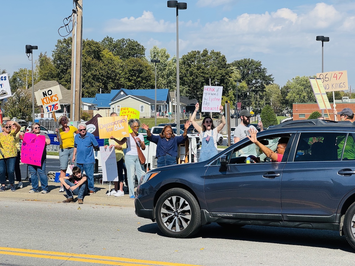 A motorist waves her support for the No Kings demonstrators Saturday, Oct. 18, 2025, in downtown Hopkinsville. Roughly 225 people participated in the rally to protest President Trump's policies. (Hoptown Chronicle photo by Jennifer P. Brown)