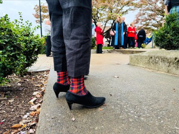 tartan plaid socks peaking out from between pants and heeled boots