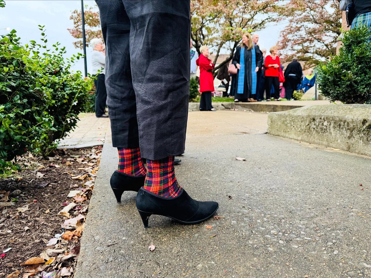 tartan plaid socks peaking out from between pants and heeled boots