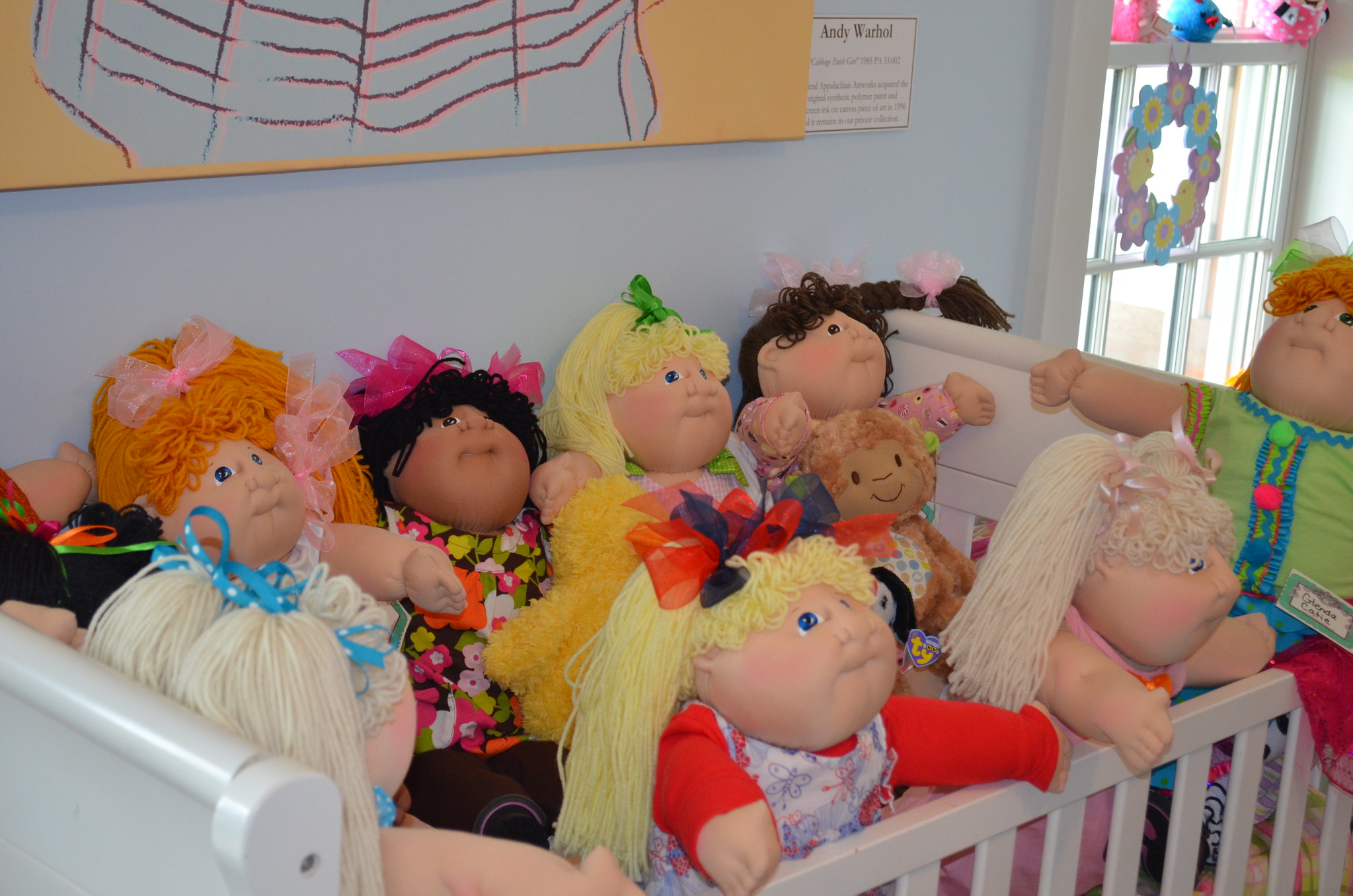Cabbage Patch Kids dolls in crib