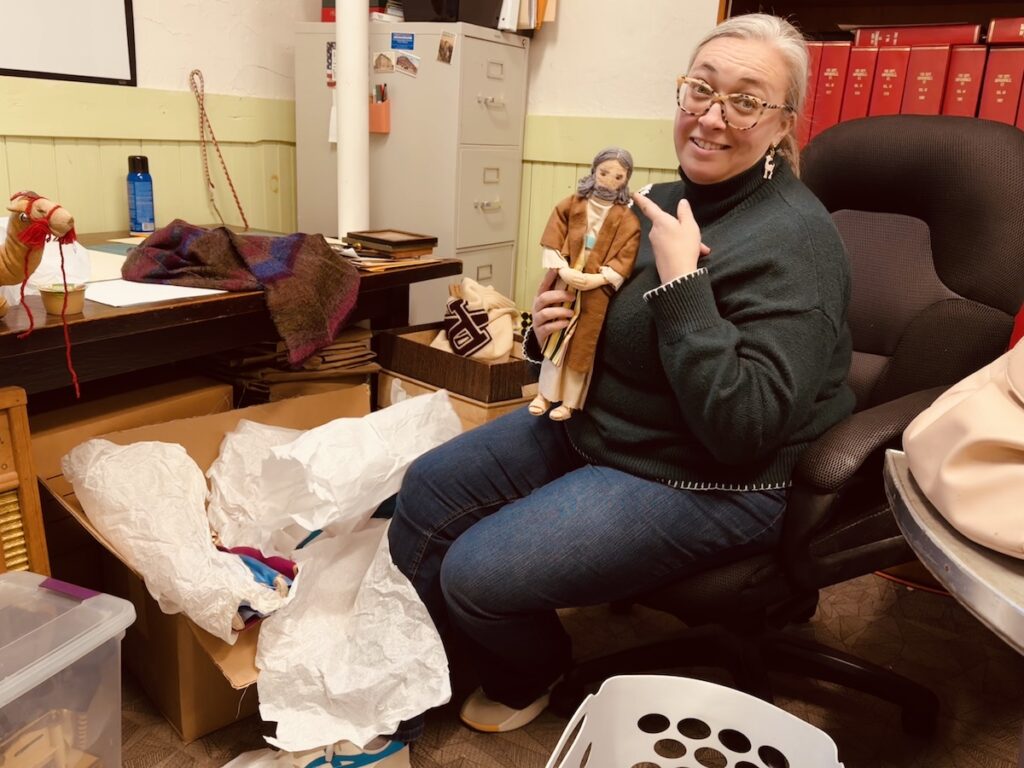 woman pointing to biblical doll