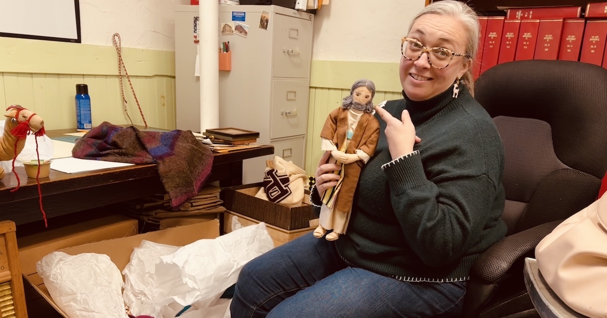 Alissa Keller, the executive director of the Museums of Historic Hopkinsville-Christian County, points to the fine detail in a hand-sewn doll of Joseph from a nativity scene. (Hoptown Chronicle photo by Jennifer P. Brown)