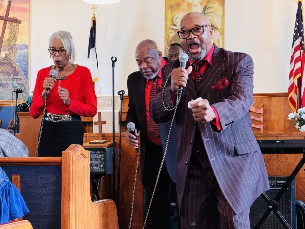 Man singing gospel with fist out