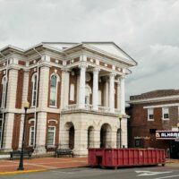 trash container in front of christian county courthouse
