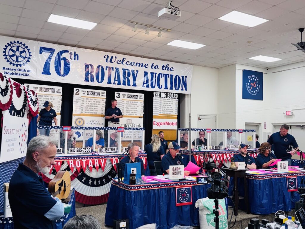 scene under 76th rotary auction banner