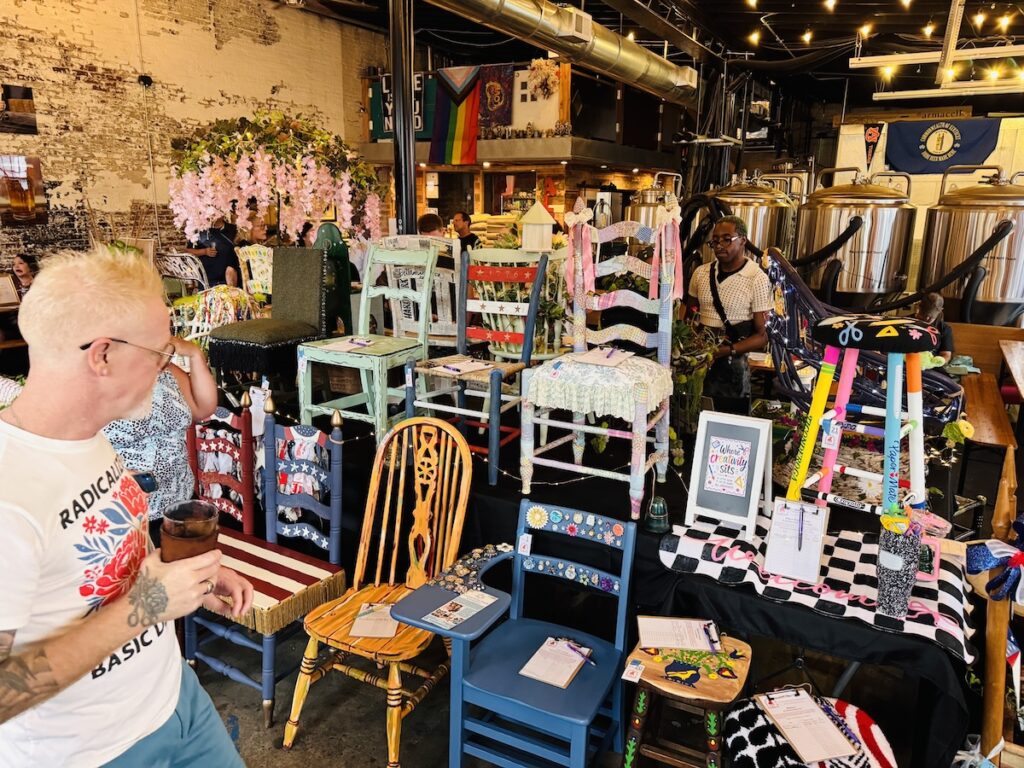 man looking at decorative chairs