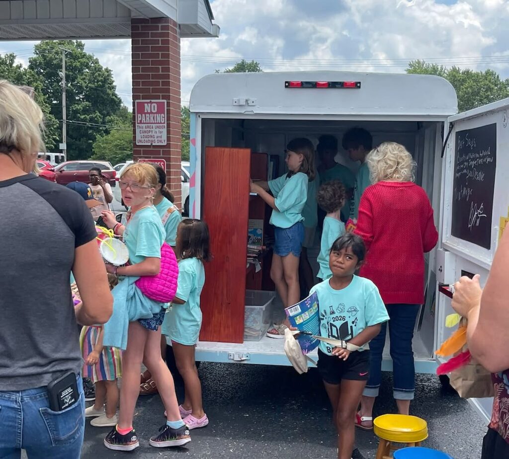 children in and around book mobile