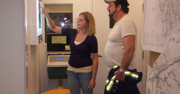 X-ray tech explaining the basics of a chest x-ray to a coal miner in Harlan County, KY as part of the  Enhanced Coal Workers' Health Surveillance Program (black lung screening). (National Institute for Occupational Safety and Health photo | Public domain)