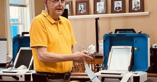 man folding tape from election results