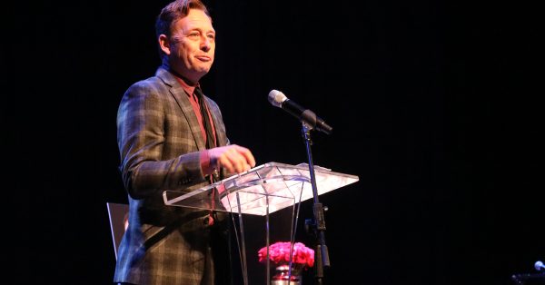 Kentucky writer Silas House speaks during a celebration of Hopkinsville native Gloria Jean Watkins, who wrote under the pen name bell hooks, on Saturday, April 2, 2022, at the Alhambra Theatre in Hopkinsville. House is the bestselling author of six novels. He became friends with hooks at Berea College. (Photo by Tony Kirves | Special to Hoptown Chronicle)