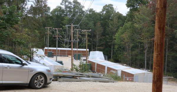Artemis Power Tech’s facility sits among the Wolfe County woods, power lines connecting it to the nearby substation. (Kentucky Lantern photo by Liam Niemeyer)