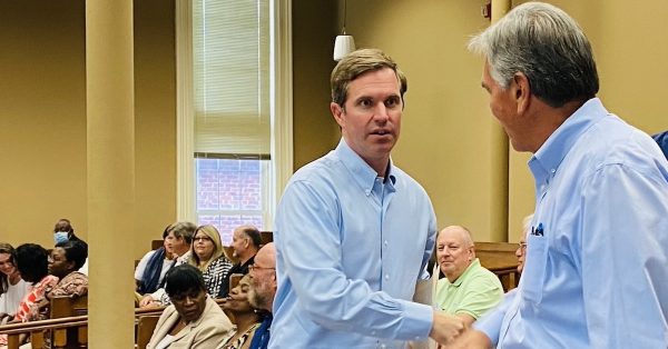 Gov. Andy Beshear shakes hands with Ashbel Brunson, a county water commissioner, as he arrives at the Christian County Courthouse on Monday, Aug. 1. (Photo by Jennifer P. Brown)