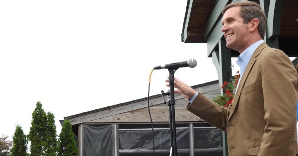 Democratic Gov. Andy Beshear speaks Friday, May 19, in downtown Paducah on the first stop of a statewide bus tour launching his campaign for re-election. (WKMS photo by Derek Operle)