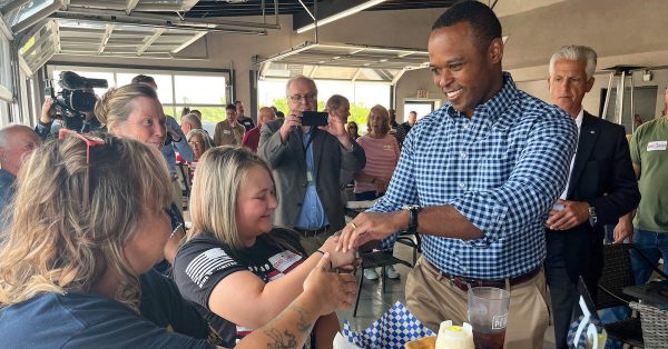 Republican Attorney General Daniel Cameron, right, shakes hands with supporters during a Tuesday, June 13, campaign stop. (Kentucky Lantern photo by McKenna Horsley)