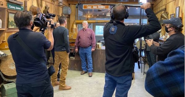A crew for “Authentic America” films distillery co-owner Arlon Casey Jones (center) with hosts Charlie and Nan Kelly inside the Christian County distillery. The segment was televised in April 2021. (Photo by Peg Hays)