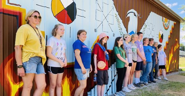 Participants in the 2022 Mural Arts Camp stand in front of their Cherokee-inspired art at the Trail of Tears Commemorative Park. (Hoptown Chronicle photo by Jennifer P.  Brown)