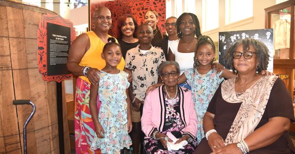 Nannie Croney (wearing a pink sweater) is surrounded by members of her family at the Eighth of August Emancipation Celebration on Sunday at the Pennyroyal Area Museum. They are (from left) Dr. Tresa Croney White, Khloe Sipp, Russhelle Croney, Ronan Croney-Sallie, Kasey Sipp, Diane Croney Turner, Rhyss Sallie, Zoe Sipp and Wanda Jones. They represent four generations of the family. (Hoptown Chronicle photo by Jennifer P. Brown)