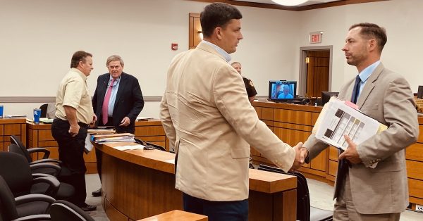 Attorney James Adams III (right) shakes hands with his client, Doug Wilcox, while attorney Ben Fletcher (right in background) speaks to his client, Mark Graham, at the conclusion of a Christian Circuit Court hearing on Tuesday, June 14, 2022, to determine the winner in the Republican primary for Ward 7 city council nominee. (Photo by Jennifer P. Brown)