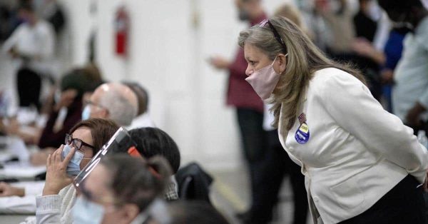 Election observer peers over shoulder