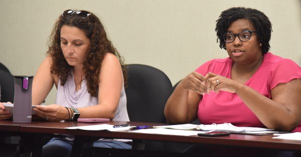 Raychel Farmer (right), executive director of the Human Rights Commission, addresses commissioners during her first board meeting as the official head of agency on Tuesday, July 25, 2023, at the Hopkinsville Municipal Center. Commissioner Yasamin Ausenbaugh is seated beside her. (Hoptown Chronicle photo by Jennifer P. Brown)