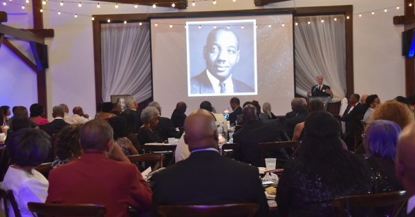 A photo of the late Louis P. McHenry is projected Saturday, July 15, at the front of The Silo Event Center for the 60th anniversary celebration of Hopkinsville's Human Rights Commission. McHenry was a key advocate for establishing HRC. (Hoptown Chronicle photo  by Jennifer P. Brown)