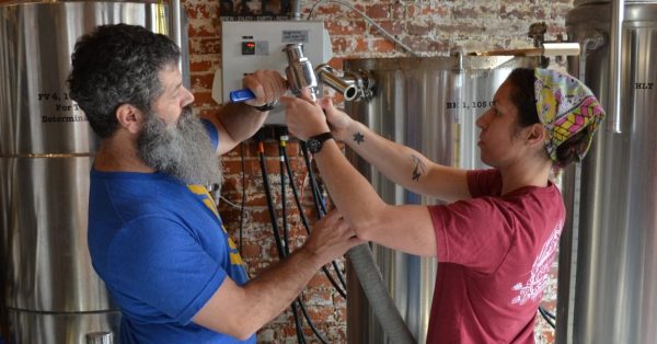 Hopkinsville Brewing Co. owners Kate Russell and Joey Medeiros work in their Hopkinsville business on Fifth Street. (Photo by Jennifer P. Brown)