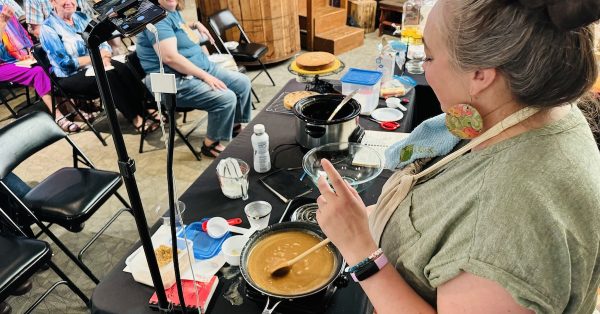 Alissa Keller stirs caramel icing during a Supper Club demonstration on Thursday, June 23, 2024, at the Pennyroyal Area Museum. The icing went on a Kentucky jam cake featured in the 1978 cookbook by Lucile Van Cleve Wallace. (Hoptown Chronicle photo by Jennifer P. Brown)