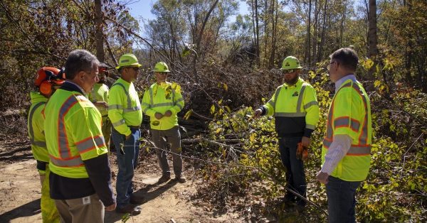 Kentucky Transportation Secretary Jim Gray (right) speaks with workers from the commonwealth who are working in North Carolina. (Kentucky Transportation Cabinet photo)