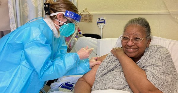 senior being vaccinated