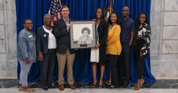 group posing with bell hooks portrait