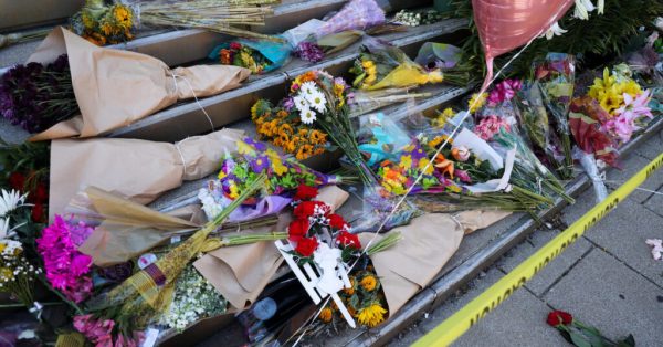 Flowers rest on steps at a memorial for victims of the April 12, 2022, mass shooting at Old National Bank in downtown Louisville. (Kentucky. Lantern photo by Abbey Cutrer)