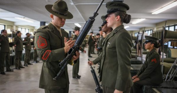 A Marine Corps staff sergeant helps conduct the final inspection of recruit training at Marine Corps Recruit Depot Parris Island, S.C., Jan. 5, 2024. During their last inspection, new Marines are tested on everything they’ve been taught, including uniform standards and discipline. (DOD Photo by Marine Corps Lance Cpl. Ava Alegria)