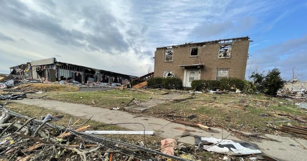 The tornado ripped the roof from this Mayfield apartment building, where at least one person rode out the storm and survived. (Photo by Liam Niemeyer, WKMS)