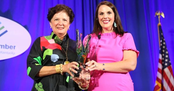 Hopkinsville banker Elizabeth McCoy (left) receives the Woman in Leadership Award from Ashli Watts, of the Kentucky Chamber, on Tuesday at the Women's Summit in Lexington. (Kentucky Chamber photo)