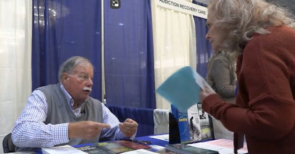 Mike Stone, executive diredctor of the Kentucky Council on Problem Gambling, talks with a potential recruit at a conference in his effort to train more problem-gambling counselors. (Image from KET)