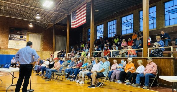 A speaker raises concerns about a proposed beef processing plant during a meeting Monday, Sept. 27, in the old Pembroke school gymnasium that is less than 2 miles from the proposed plant on John Rivers Road. (Photo by Jennifer P. Brown)