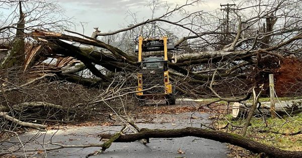 Debris is cleared from a street in Pembroke on Saturday, Dec. 11, following storms that battered the area. (Pembroke Fire Department photo)