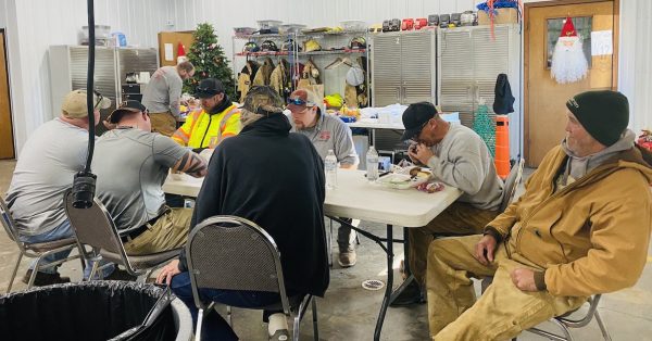 Recovery workers take a meal break Monday morning at the Pembroke Fire Department, where supporters have been delivering meals, snacks, water and supplies for the community after a tornado ripped through the older sections of town. (Photo by Jennifer P. Brown)
