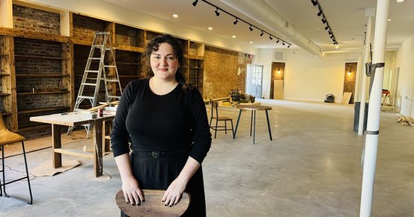 Rachel Sanders stands in the East Ninth Street building where construction continued on Oct. 9, 2024, for her business, The Book & Bottle Shop. (Hoptown Chronicle photo by Jennifer P. Brown)