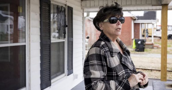 Gregg Knight, 58, stands on her porch in Mayfield Tuesday, January 24, 2023 in Graves County, Kentucky. Knight quit her job as a case manager for the Team Western Kentucky Tornado Relief Fund because she didn’t feel the distribution of funds was happening in an equitable way. (Julia Rendleman for the Kentucky Lantern)