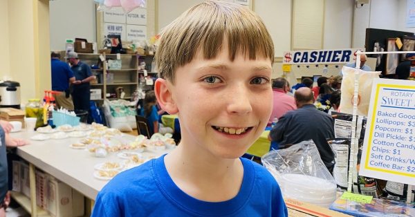 Preston Killebrew works in the Sweet Shop where he sells desserts and popcorn at the Hopkinsville Rotary Auction. He is the 11-year-old son of auction chairman Brandon Killebrew and Kiley Killebrew, also a Rotarian. (Hoptown Chronicle photo by Jennifer P. Brown)