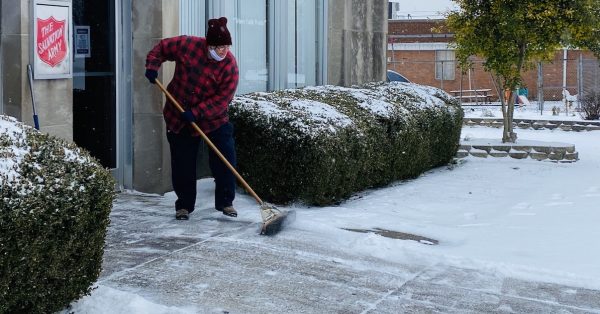 sweeping snow outside of salvation army