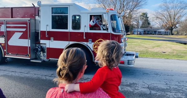 Santa Claus waves from the cab of a Hopkinsville fire truck on Dec. 21, 2020, in the Hunting Creek subdivision.