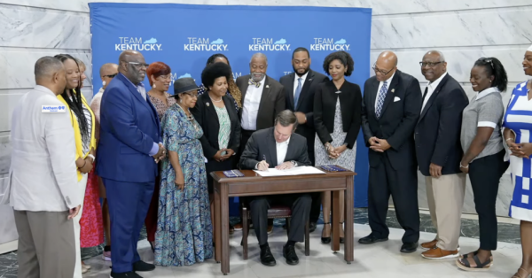 Gov. Andy Beshear signed executive orders during a gathering in the Capitol Rotunda Thursday. (Screenshot)