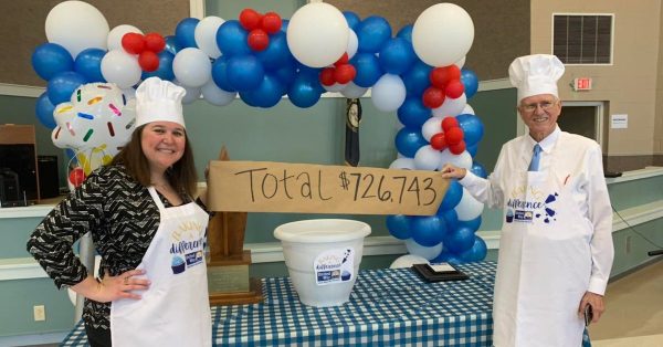 United Way campaign co-chairs Brooke Jung and Dan Kemp posed with a display of their efforts, during a celebration on Thursday, April 14, 2022, at the Christian County Senior Citizens  Center. (United Way photo)