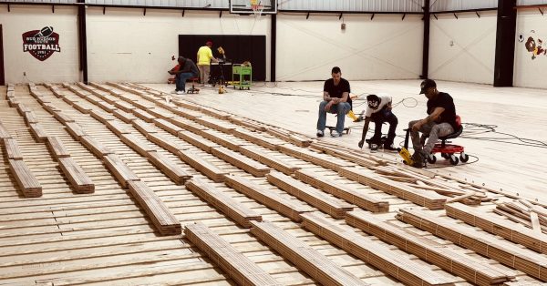 A crew for Conrad Floors, based in Smiths Grove, Kentucky, works on May 15, 2025, to install a new gym floor at the Boys and Girls Club of Hopkinsville-Christian County. The installation is part of a gym renovation honoring the parents of Hopkinsville native Tommy Wade. (Hoptown Chronicle photo by Jennifer P. Brown)