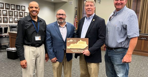 Hopkinsville Mayor Wendell Lynch (far left), Kentucky League of Cities Executive Director and CEO James D. Chaney (second from left) and Christian County Magistrate Jerry Gilliam (far right) present Rep. Walker Thomas with a 2022 “Friend of Kentucky Cities” award. (Kentucky League of Cities photo)