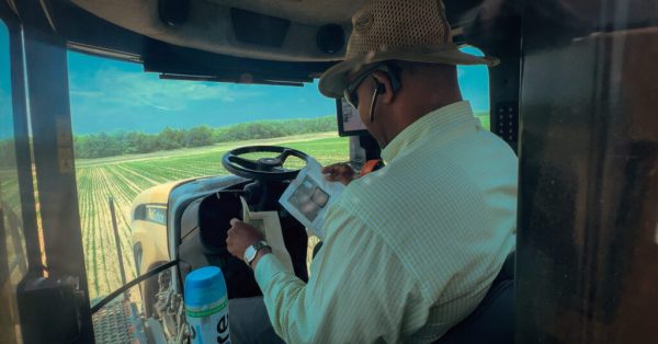 black farmer driving tractor