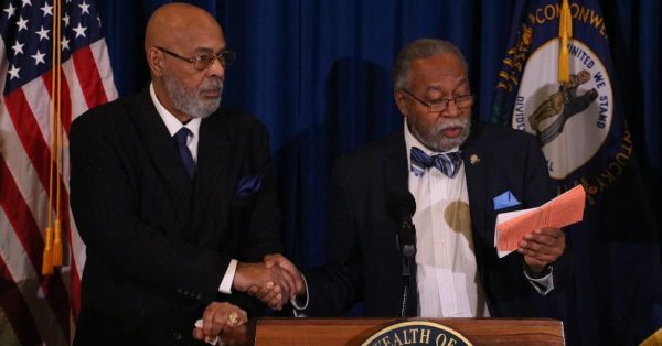 Charles Blatcher III, chairman of the National Coalition of Black Veteran Organizations, shakes Kentucky Senate Minority Leader Gerald Neal’s hand during a ceremony on Tuesday, Feb. 7, 2023, in the Capitol Rotunda. (Kentucky Lantern photo by Liam Niemeyer)